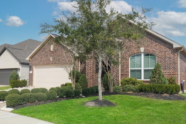 view of front of property with a front lawn, brick siding, and an attached garage