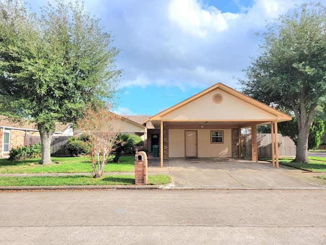 view of front of property with a carport and a front lawn