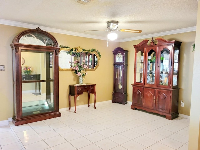 interior space featuring ceiling fan, a textured ceiling, and ornamental molding