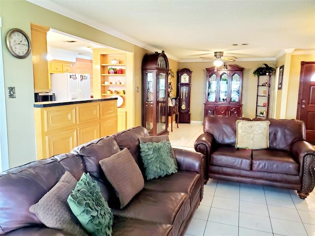 living room with ceiling fan, light tile patterned flooring, built in features, and crown molding