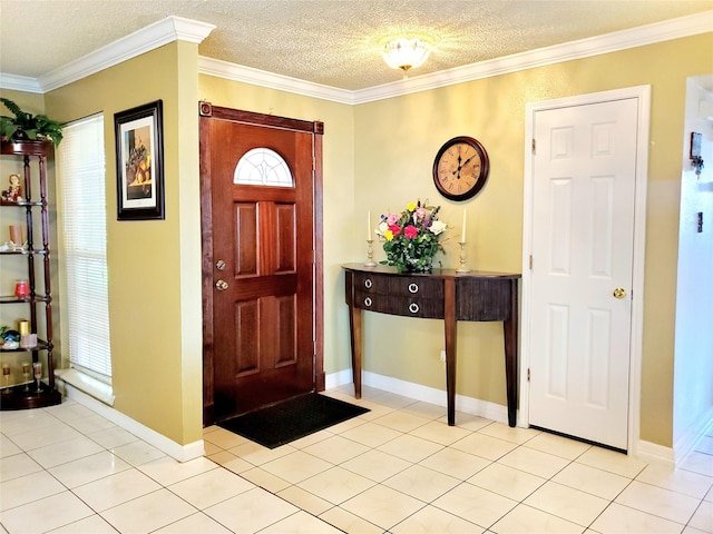 tiled entryway with a textured ceiling and ornamental molding