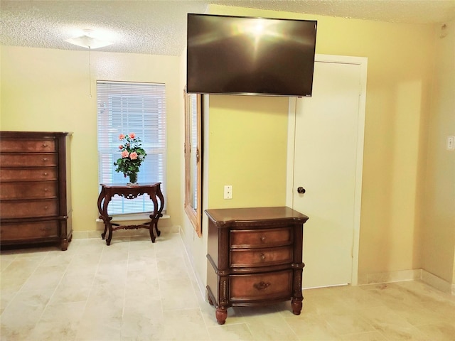 3827 Monmouth Ln, Pasadena, TX 77505 - bedroom with a textured ceiling, baseboards, and light tile patterned floors