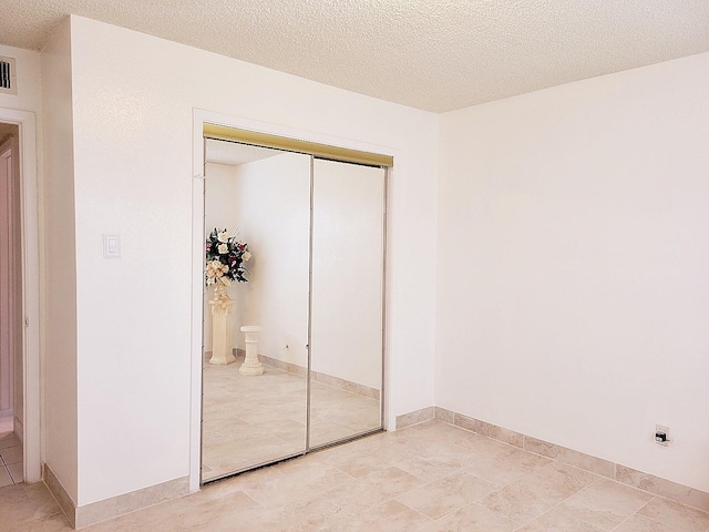 3827 Monmouth Ln, Pasadena, TX 77505 - unfurnished bedroom with a closet and a textured ceiling