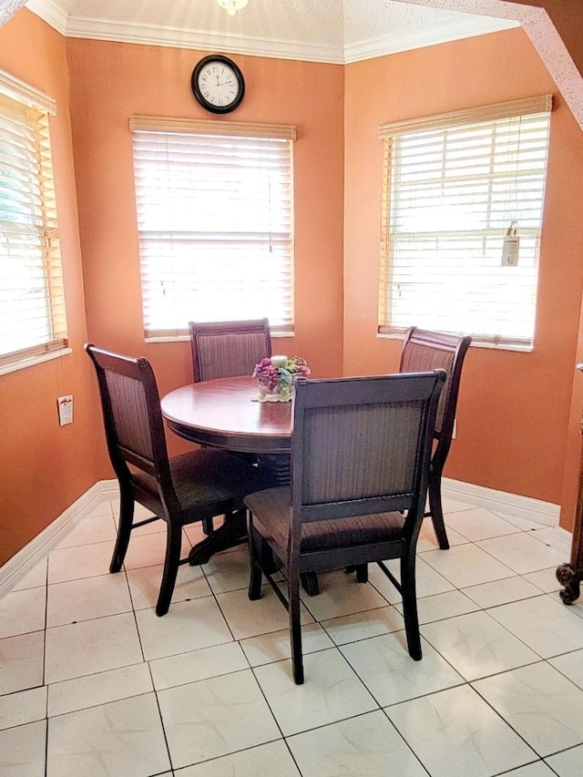 dining space featuring a textured ceiling, tile patterned floors, and crown molding