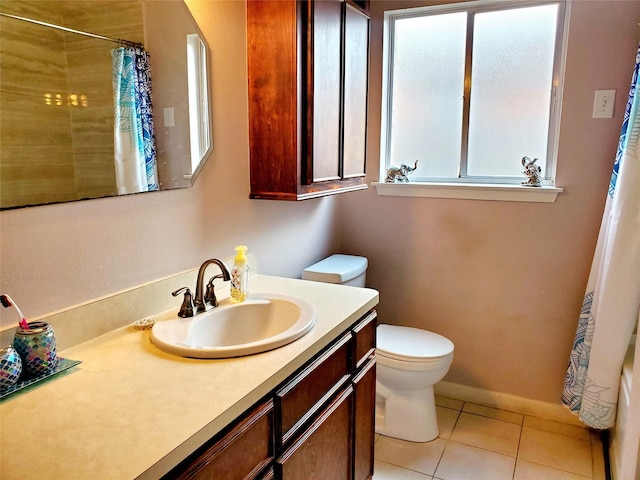 bathroom with tile patterned flooring, vanity, and toilet