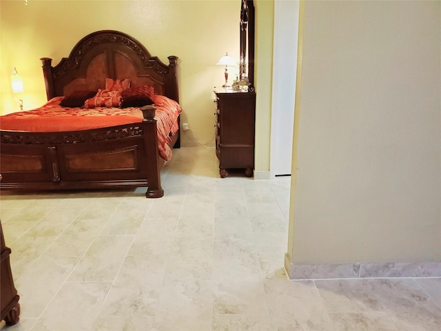 bedroom with light tile patterned floors