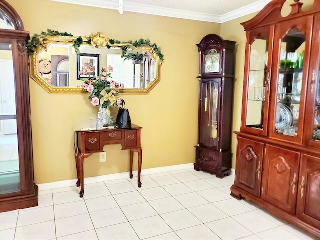 entryway featuring light tile patterned floors and ornamental molding