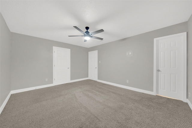 unfurnished room featuring ceiling fan and carpet floors