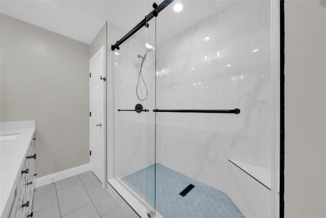 bathroom featuring tile patterned flooring, vanity, and walk in shower