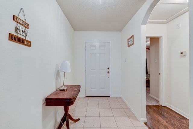 tiled entrance foyer featuring a textured ceiling