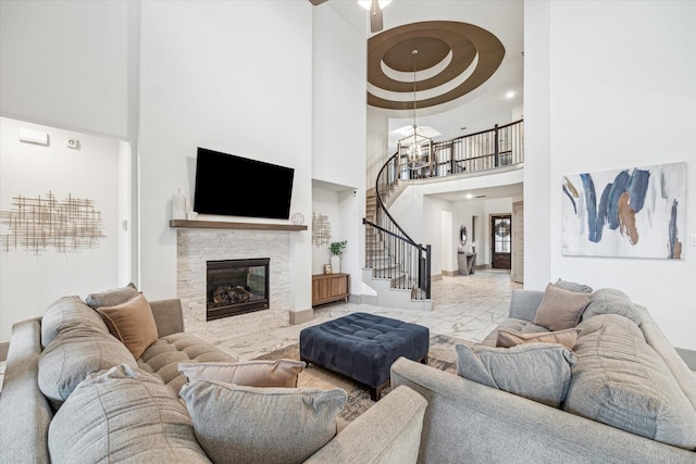 living room with a fireplace and a high ceiling