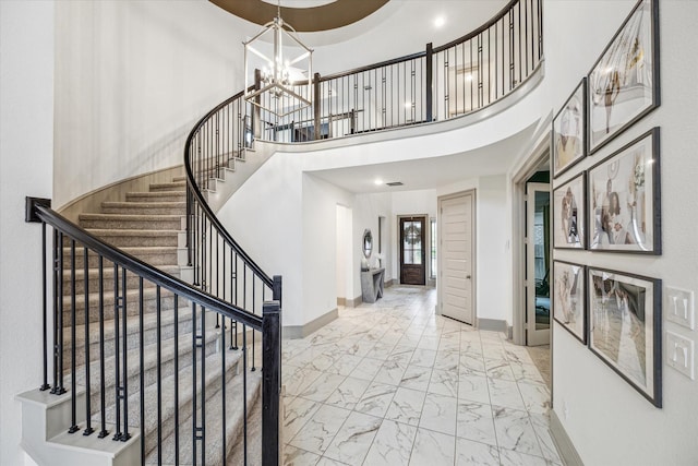 entrance foyer featuring a chandelier and a towering ceiling