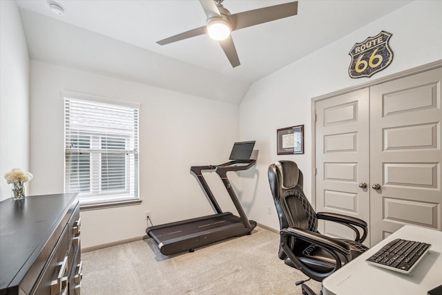 carpeted home office featuring vaulted ceiling and ceiling fan