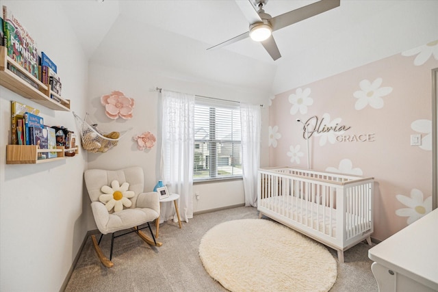 bedroom featuring carpet floors, vaulted ceiling, a nursery area, and ceiling fan