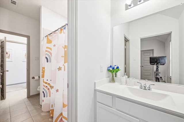 bathroom featuring toilet, vanity, tile patterned floors, and a shower with shower curtain