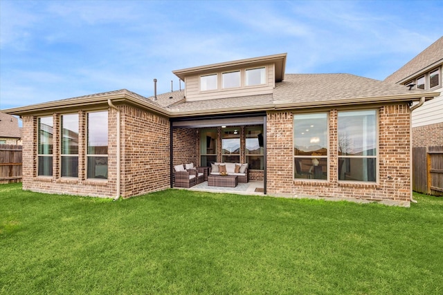 rear view of house with a yard, an outdoor living space, and a patio