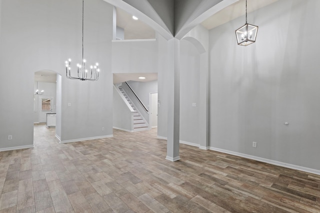 entrance foyer featuring hardwood / wood-style flooring and a towering ceiling