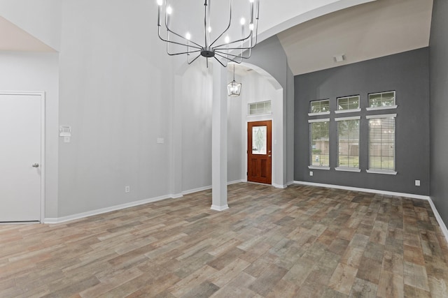 foyer with a towering ceiling and hardwood / wood-style floors