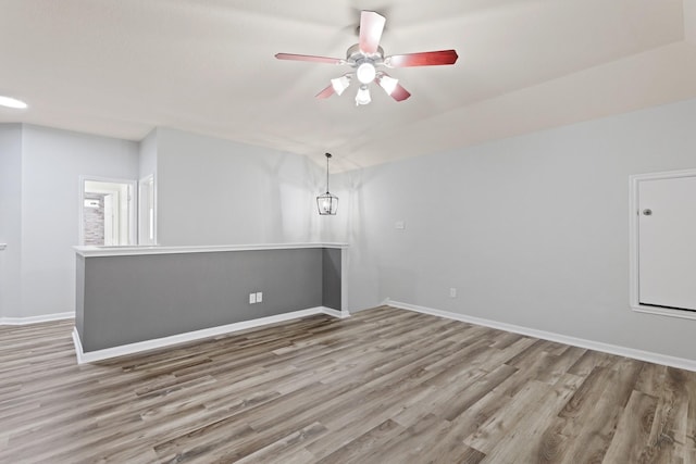 spare room with ceiling fan and light wood-type flooring