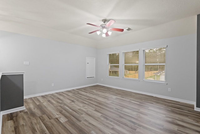 unfurnished room with hardwood / wood-style floors and ceiling fan