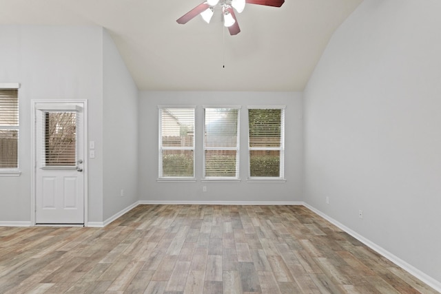 unfurnished room with ceiling fan, light hardwood / wood-style floors, and vaulted ceiling