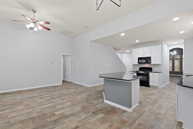 kitchen featuring ceiling fan, white cabinets, light wood-type flooring, and black appliances