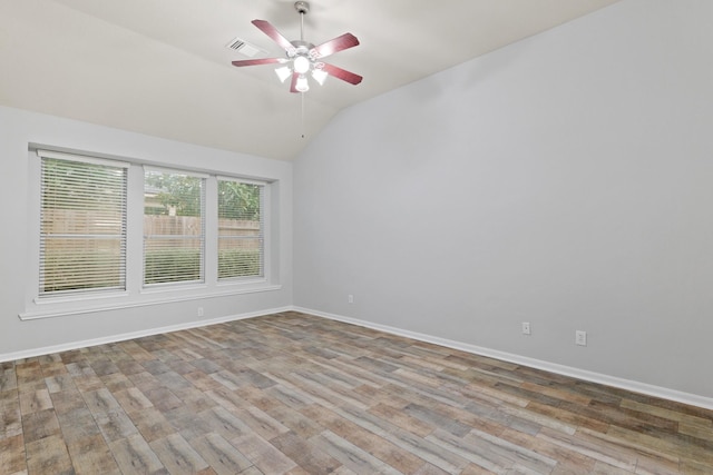 unfurnished room featuring lofted ceiling, ceiling fan, and light wood-type flooring