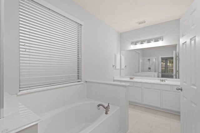 bathroom featuring vanity, tile patterned flooring, and plus walk in shower