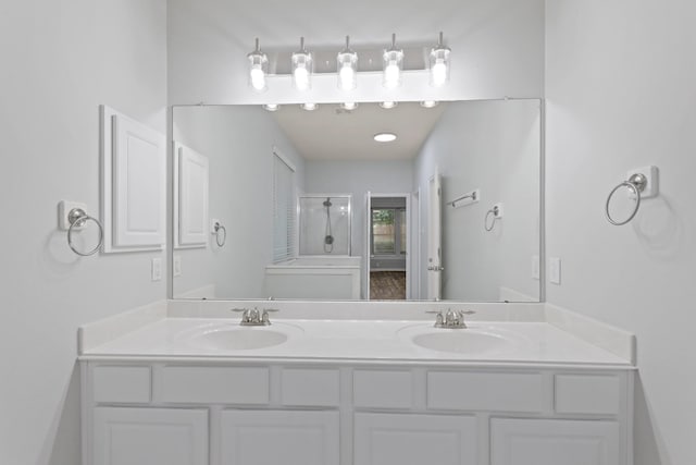 bathroom with vanity and a shower with door