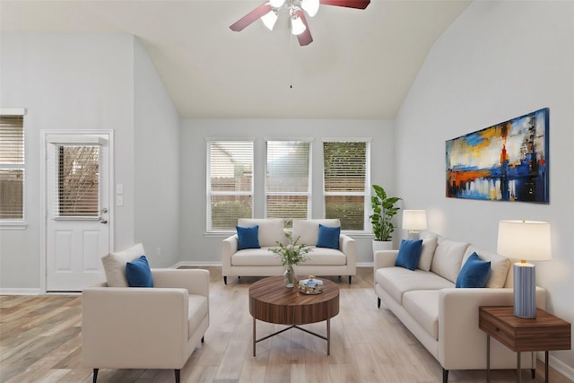 living room featuring vaulted ceiling, ceiling fan, and light wood-type flooring