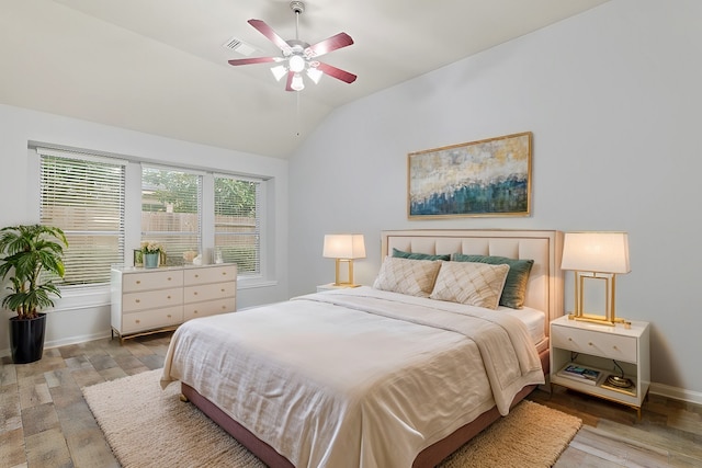 bedroom with vaulted ceiling, light hardwood / wood-style floors, and ceiling fan