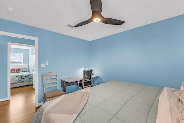 bedroom featuring ceiling fan and hardwood / wood-style flooring