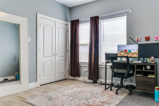 office area with light hardwood / wood-style floors