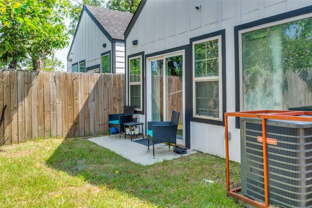 back of property with a yard, a patio, and central air condition unit