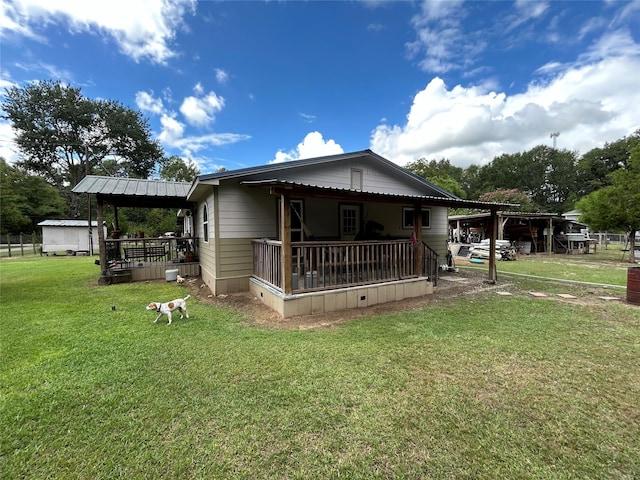 rear view of property featuring a yard