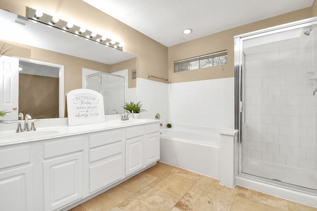 bathroom with tile patterned flooring, a textured ceiling, vanity, and independent shower and bath