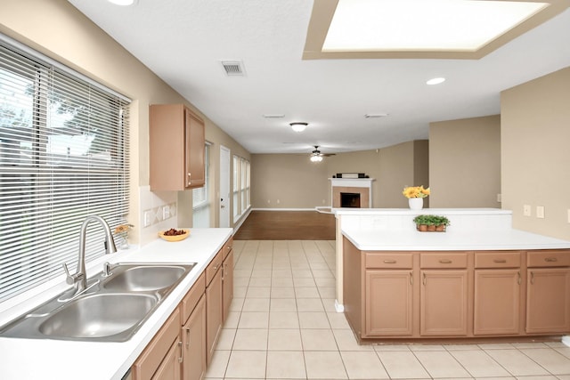 kitchen featuring ceiling fan, light tile patterned flooring, and sink