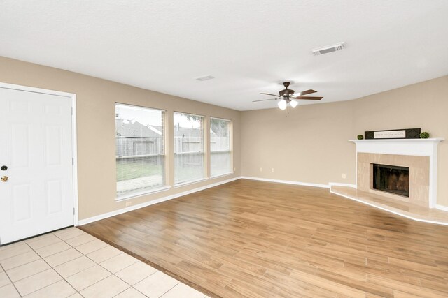 unfurnished living room with ceiling fan and light hardwood / wood-style flooring