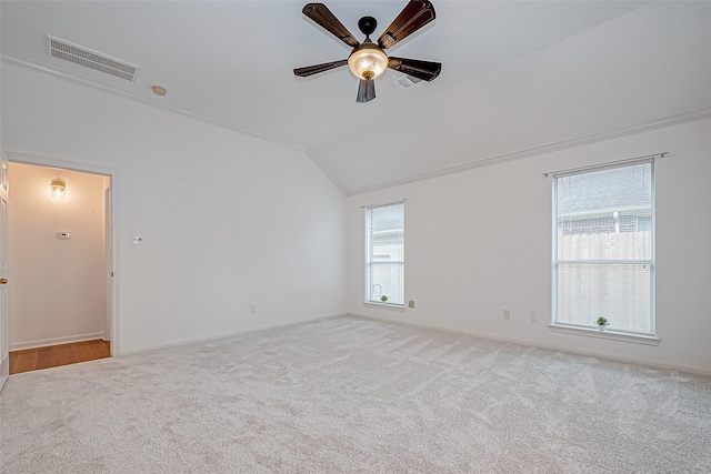 unfurnished room with light carpet, crown molding, ceiling fan, and lofted ceiling