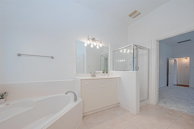 bathroom featuring tile patterned flooring, vanity, and separate shower and tub