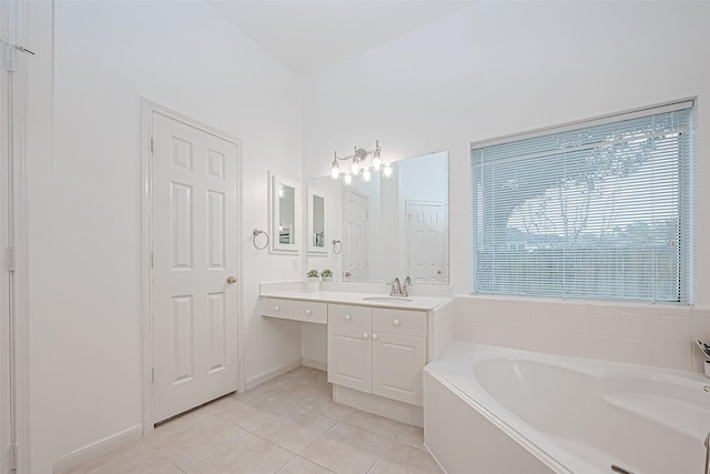 bathroom with tile patterned flooring, vanity, and a washtub