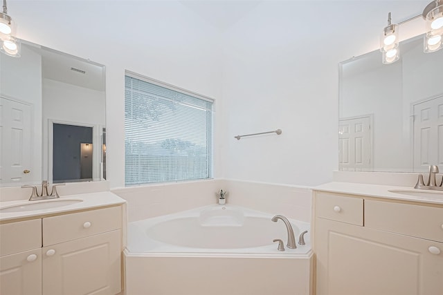 bathroom featuring a washtub and vanity