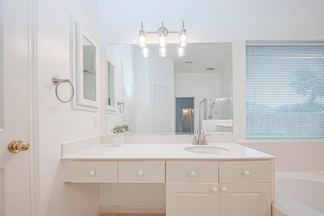 bathroom with vanity and independent shower and bath