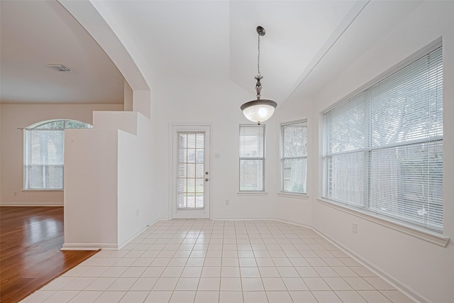 tiled empty room featuring a healthy amount of sunlight