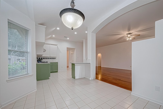 empty room with ceiling fan and light tile patterned flooring