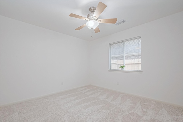 empty room with ceiling fan and light colored carpet