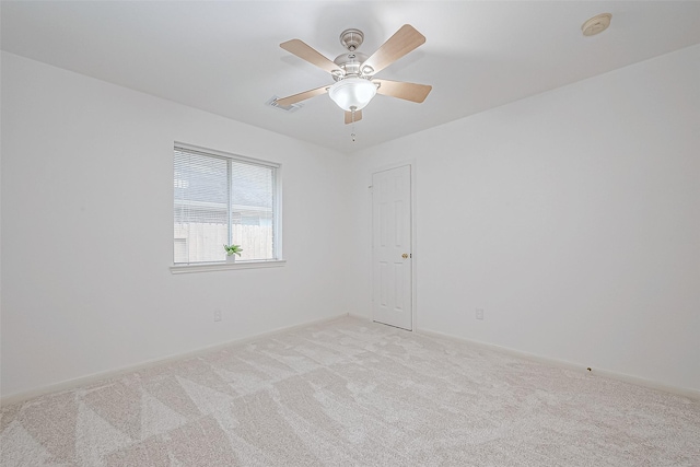 spare room with light carpet and ceiling fan