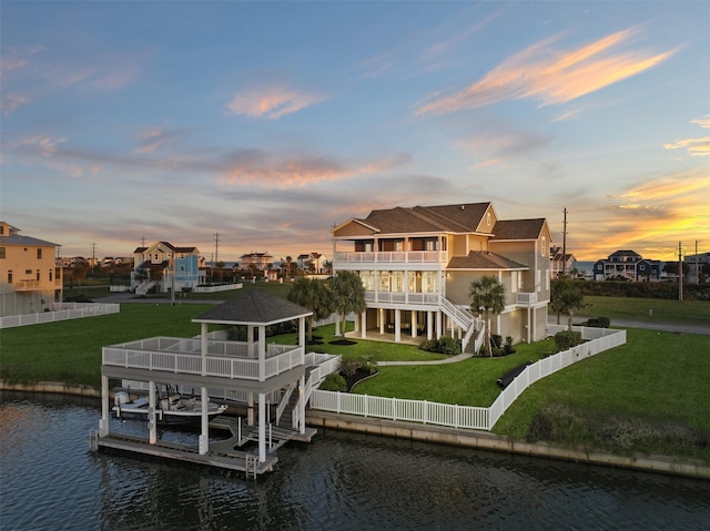 exterior space with a yard, a balcony, and a water view