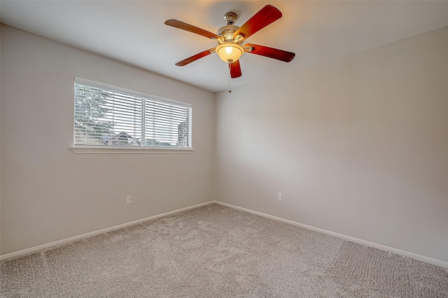 spare room featuring carpet flooring and ceiling fan