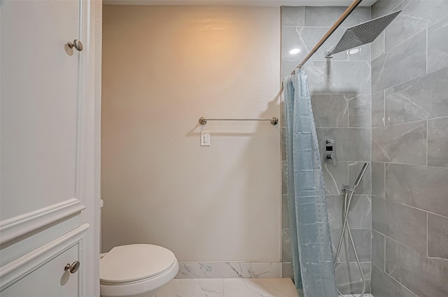 bathroom with a shower with curtain and toilet